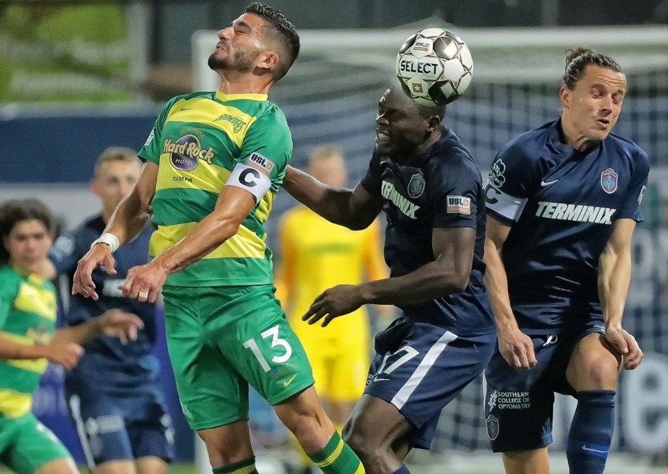 <strong>Ewan Grandison (17) and Marc Burch (right) beat Tampa's Sebastian Guenzatti (13) to a header during the 901 FC season opener against the Tampa Rowdies at AutoZone Park on March 9, 2019. </strong>(Jim Weber/Daily Memphian file)