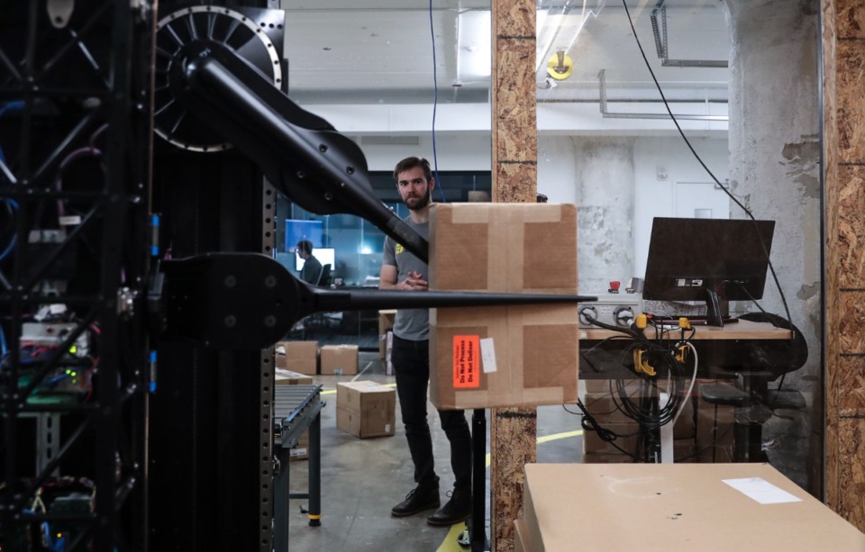 <strong>Sam Zapolsky demonstrates an unloading robot developed by Dextrous Robotics at their Crosstown Concourse office Sept. 20, 2022.</strong> (Patrick Lantrip/Daily Memphian)