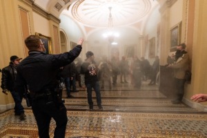 <strong>Smoke fills the walkway outside the Senate chamber as supporters of President Donald Trump are confronted by U.S. Capitol Police officers inside the Capitol in Washington on Jan. 6, 2021.</strong> (Manuel Balce Ceneta/AP file)