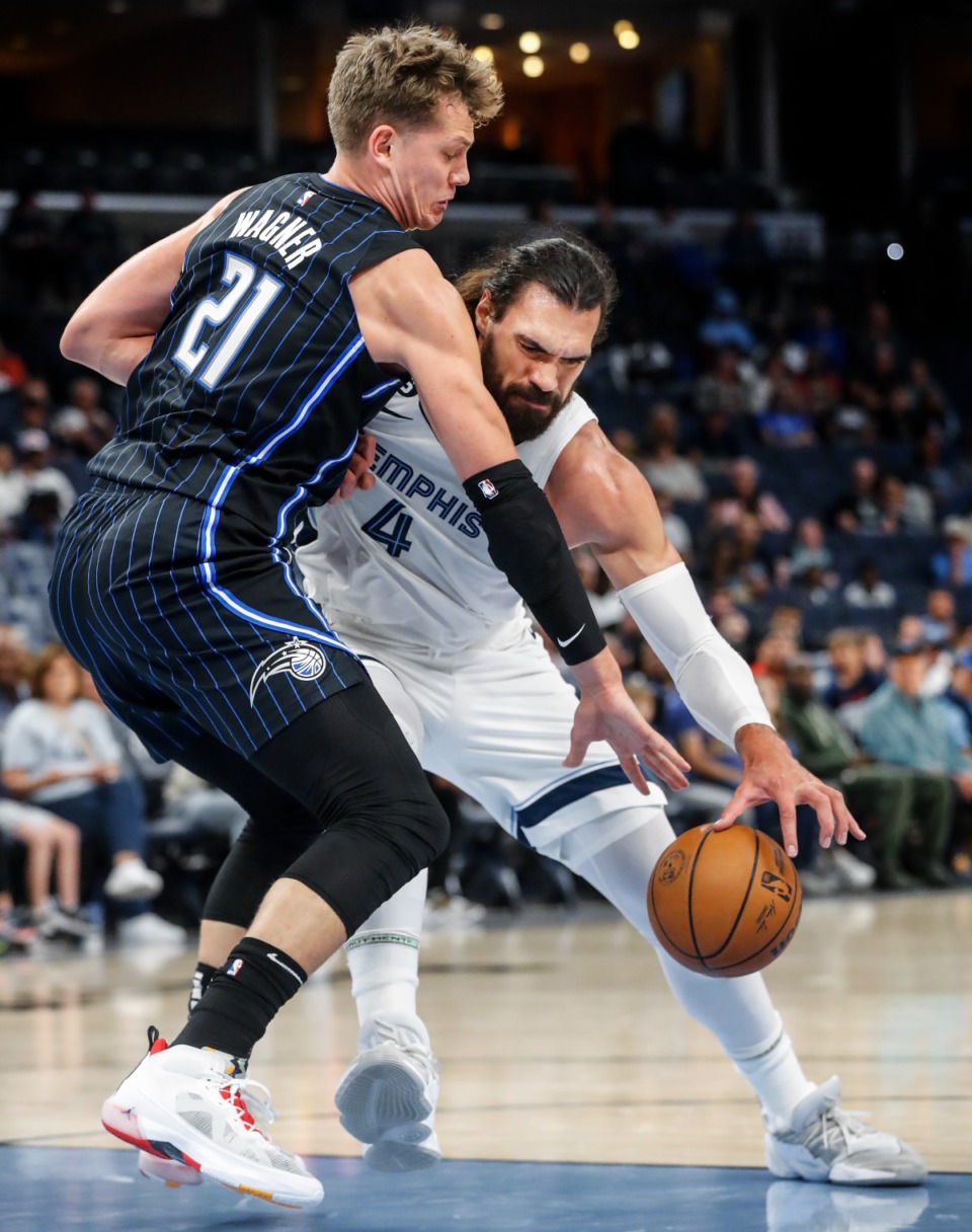 <strong>Memphis Grizzlies center Steven Adams (left) loses control of the ball while driving the lane against Orlando Magic defender Moritz Wagner (right) on Monday, Oct. 3, 2022.</strong> (Mark Weber/The Daily Memphian)