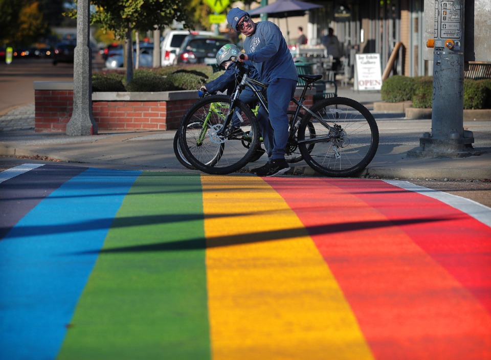 <strong>Cyclists pause at the state&rsquo;s first rainbow colored crosswalk the day it opened in 2019. About 20 volunteers will finish work on the crosswalk at Cooper Street and Young Avenue this weekend.</strong> (Jim Weber/The Daily Memphian file)