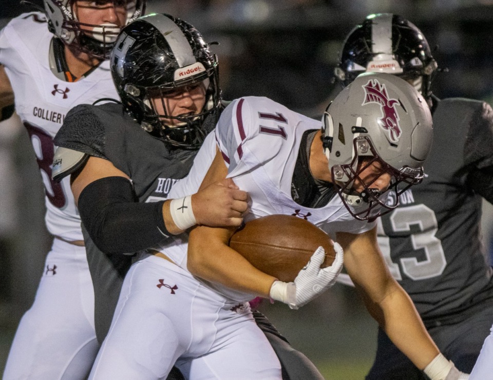 <strong>Houston High School tight end Ian Bullock stops Collierville running back Logan Davis on Oct. 6, 2022. Collierville suffered their first loss, 34-6.</strong> (Greg Campbell/Special to The Daily Memphian)