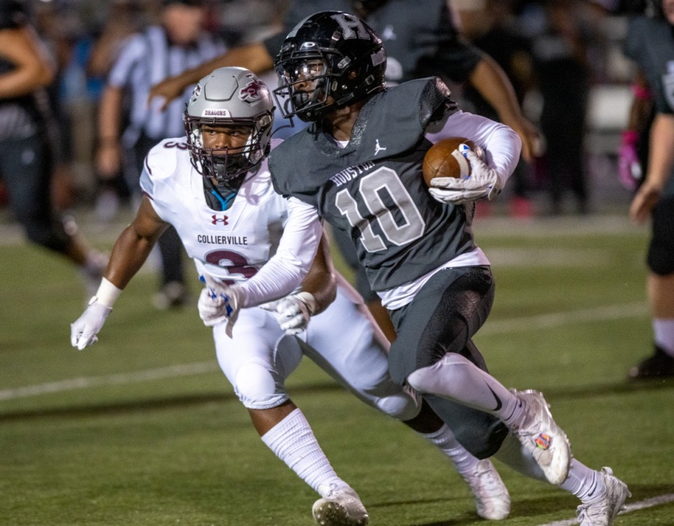 <strong>Houston running back Damon Sisa cuts upfield with Collierville's Jonathan Hampton in pursuit at Houston High School on Thursday, Oct. 6, 2022.</strong> (Greg Campbell/Special to The Daily Memphian)