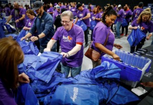 <strong>Hundreds of FedEx employees fill USO care packages that will be distributed to men and women in uniform this holiday season.</strong> (Mark Weber/The Daily Memphian)