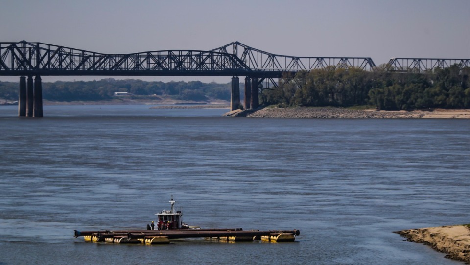 <strong>Crews move pipes across the Wolf River Harbor in Downtown Memphis on Oct. 6, 2022.&nbsp;Near-historic low water levels on the Mississippi River have caused barge traffic to slow and rates to increase.&nbsp;</strong> (Patrick Lantrip/Daily Memphian)