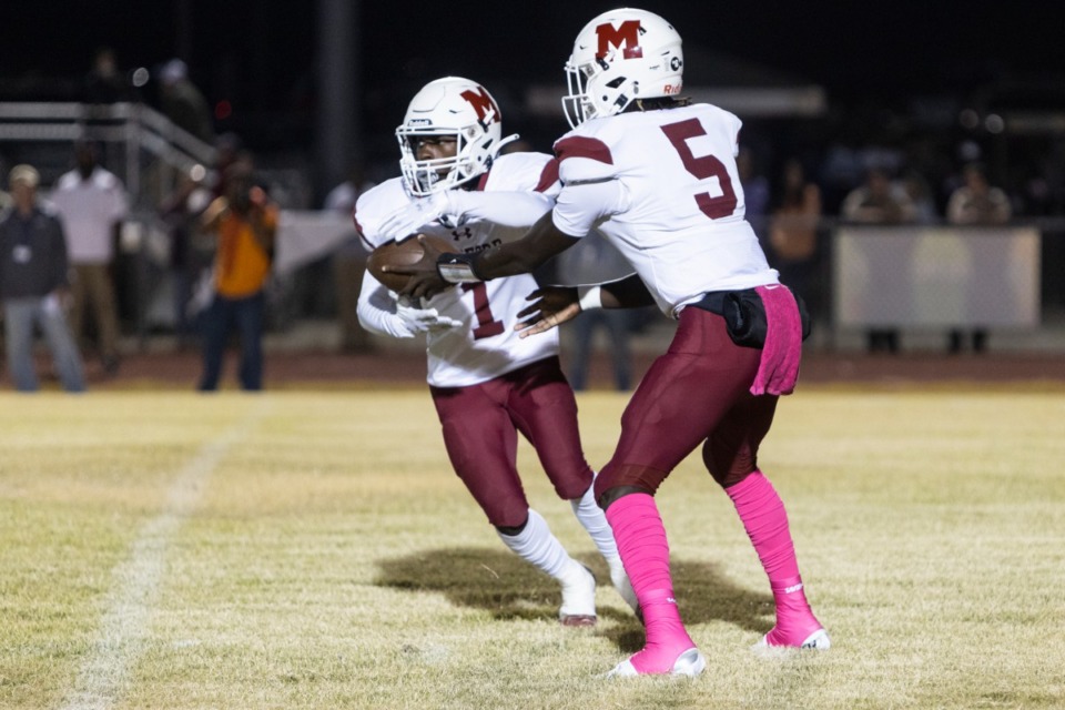 <strong>Munford&rsquo;s quarterback Jordan Bell, right, hands the ball off to Braxton Sharp during Friday night&rsquo;s game against Southwind.</strong> (Brad Vest/Special to The Daily Memphian)