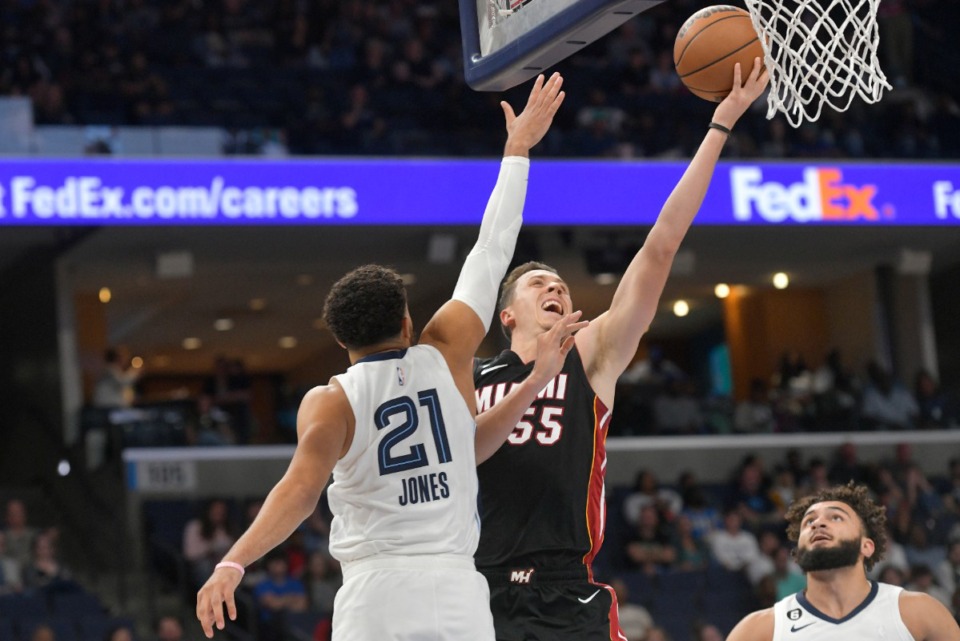 <strong>Miami Heat guard Duncan Robinson (55) shoots against Memphis Grizzlies guard Tyus Jones (21) in the first half of a preseason game on Friday, Oct. 7, 2022.</strong> (Brandon Dill/AP)