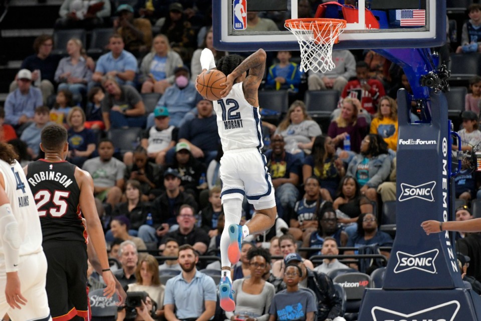 <strong>Memphis Grizzlies guard Ja Morant (12) goes up for a dunk against the Miami Heat in the first half&nbsp;of a preseason game on Friday, Oct. 7, 2022.</strong> (Brandon Dill/AP)