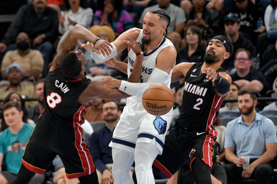 <strong>Memphis Grizzlies forward Dillon Brooks (middle) struggles for control of the ball against Miami Heat forward Jamal Cain (8) and guard Gabe Vincent (2) in the first half&nbsp;of a preseason game on Friday, Oct. 7, 2022.</strong> (Brandon Dill/AP)