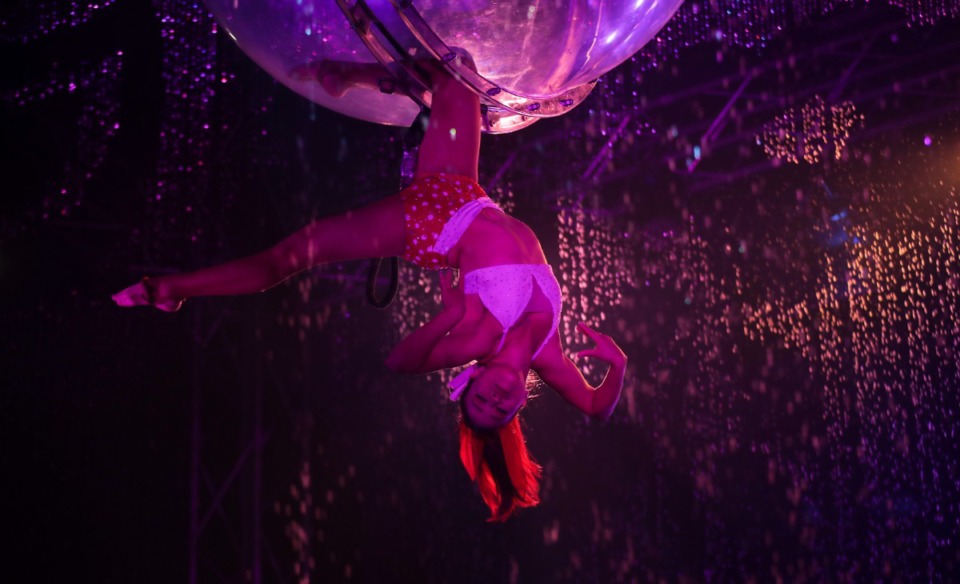<strong>An acrobat dangles from a translucent sphere during the Cirque Italia Water Circus outside Wolfchase Mall. </strong>(Patrick Lantrip/The Daily Memphian)