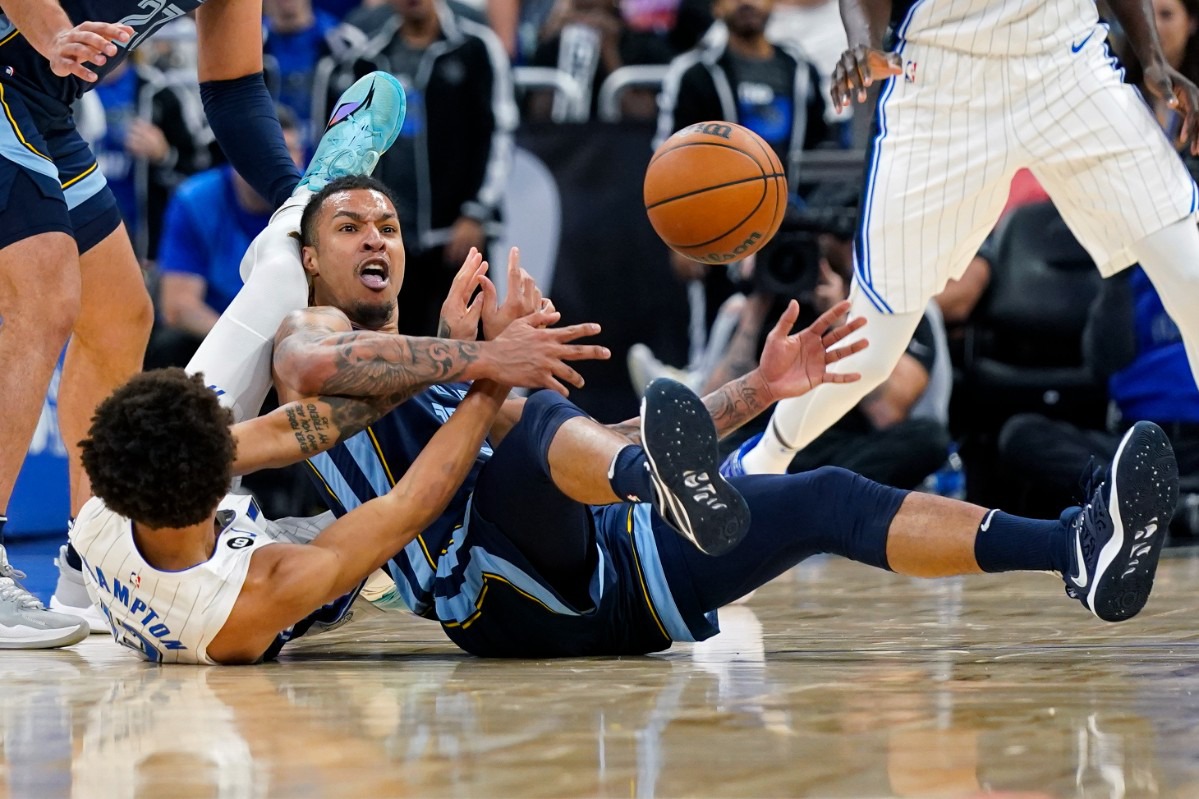 <strong>Orlando Magic's R.J. Hampton, lower left, and Memphis Grizzlies' Brandon Clarke vie for a loose ball&nbsp;on Oct. 11, 2022, in Orlando, Florida.</strong> (John Raoux/AP)