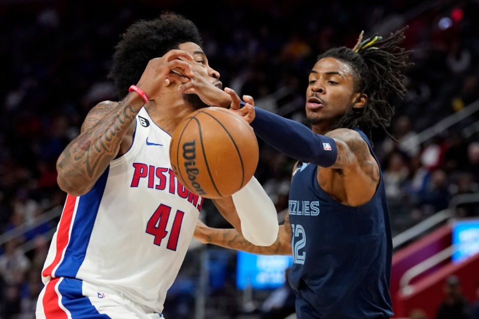 <strong>Memphis Grizzlies guard Ja Morant (12) deflects the ball away from Detroit Pistons forward Saddiq Bey (41)&nbsp;on Oct. 13, 2022, in Detroit.</strong> (Carlos Osorio/AP)