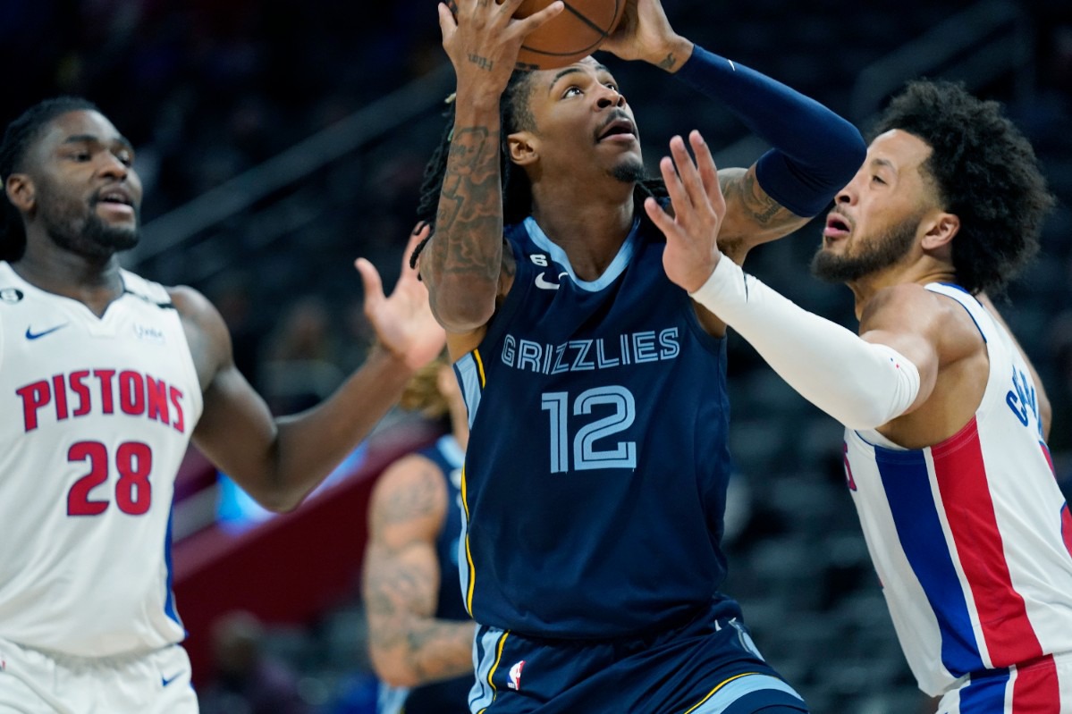 <strong>Memphis Grizzlies guard Ja Morant (12) attempts a layup as Detroit Pistons guard Cade Cunningham, right, defends on Oct. 13, 2022, in Detroit.</strong> (Carlos Osorio/AP)