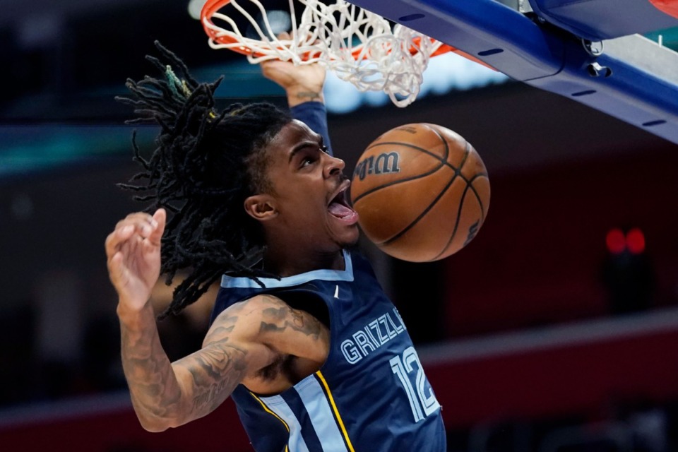 <strong>Memphis Grizzlies guard Ja Morant dunks during the second half of an NBA preseason basketball game against the Detroit Pistons on Thursday, Oct. 13, 2022, in Detroit.</strong> (Carlos Osorio/AP)