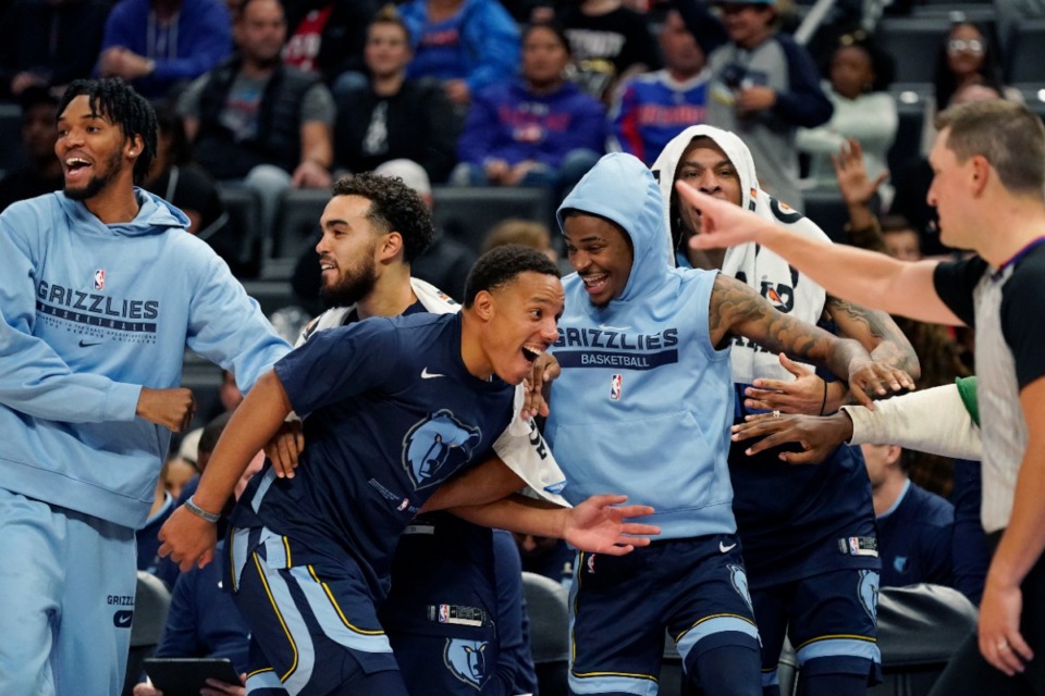 <strong>Team players from the Memphis Grizzlies react after a teammate's dunk during the second half of an NBA preseason basketball game against the Detroit Pistons on Thursday, Oct. 13, 2022, in Detroit.</strong> (Carlos Osorio/AP)