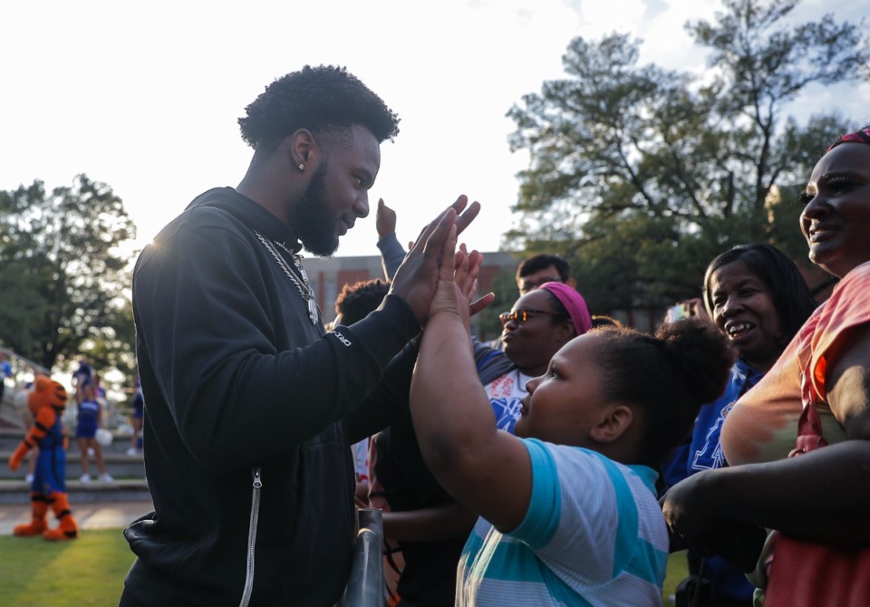 <strong>Alex Lomax high fives a fan at the Memphis Basketball Block Party Oct. 15, 2022.</strong> (Patrick Lantrip/The Daily Memphian)
