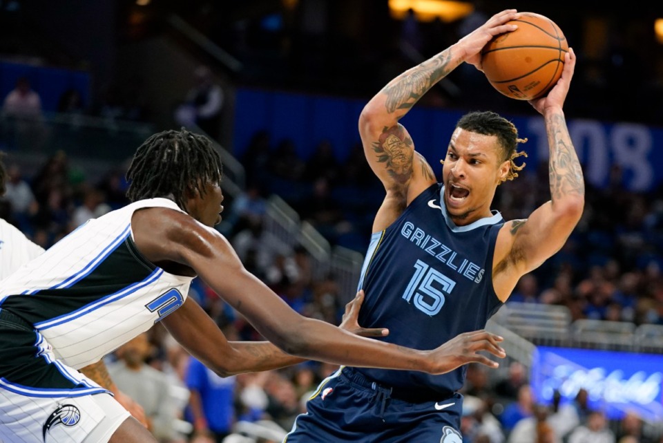 <strong>Memphis Grizzlies' Brandon Clarke (15) looks to pass the ball as he is defended by Orlando Magic's Bol Bol, left, during the second half of an NBA preseason basketball game Tuesday, Oct. 11, 2022, in Orlando, Fla.</strong> (AP Photo/John Raoux)