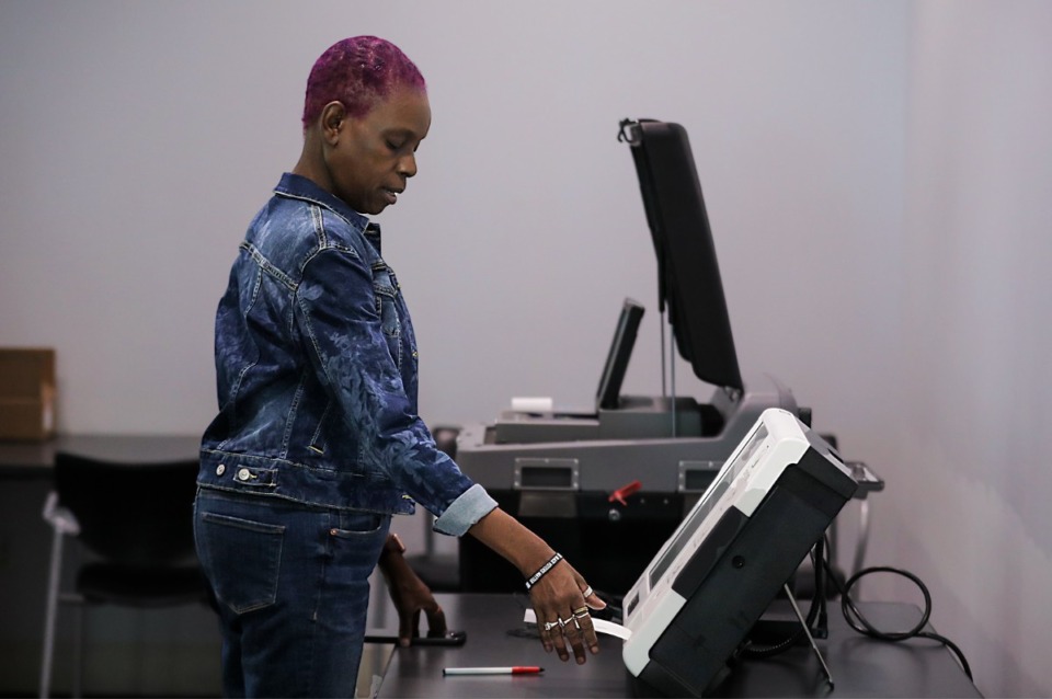 <strong>Rev. Regina Clarke with the Cathedral of Praise Memphis tests out the new voting machines.&nbsp;If you leave the polling place with the piece of paper from either way of voting, you cannot come back in to scan it and your vote will not be counted.</strong> (Patrick Lantrip/The Daily Memphian file)