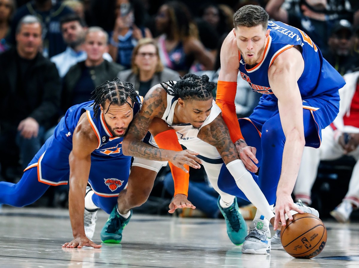 <strong>Memphis Grizzlies guard Ja Morant (middle) battles New York Knicks defenders Jalen Brunson (left) and Isaiah Hartenstein (right) for a loose ball on Wednesday, Oct. 19, 2022.</strong> (Mark Weber/The Daily Memphian)