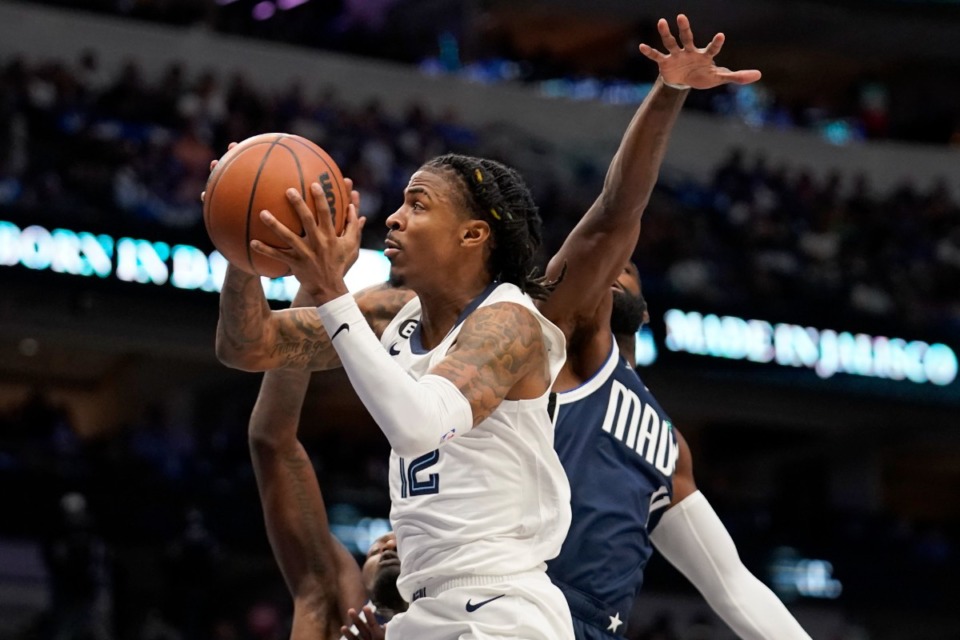 <strong>Memphis Grizzlies guard Ja Morant, front, leaps to the basket for a shot past Dallas Mavericks forward Tim Hardaway Jr., right, during the first half of an NBA basketball game in Dallas, Saturday, Oct. 22, 2022.</strong> (AP Photo/Tony Gutierrez)