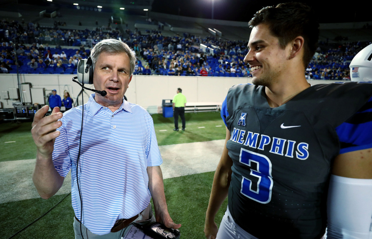 <strong>Daily Memphian columnist Geoff Calkins discusses offensive plays with University of Memphis quarterback Brady White (3) during the annual Friday Night Stripes scrimmage on April 12, 2019. Calkins was among a select group of guest coaches who were invited to call plays for a quarter of the game.</strong> (Houston Cofield/Daily Memphian)