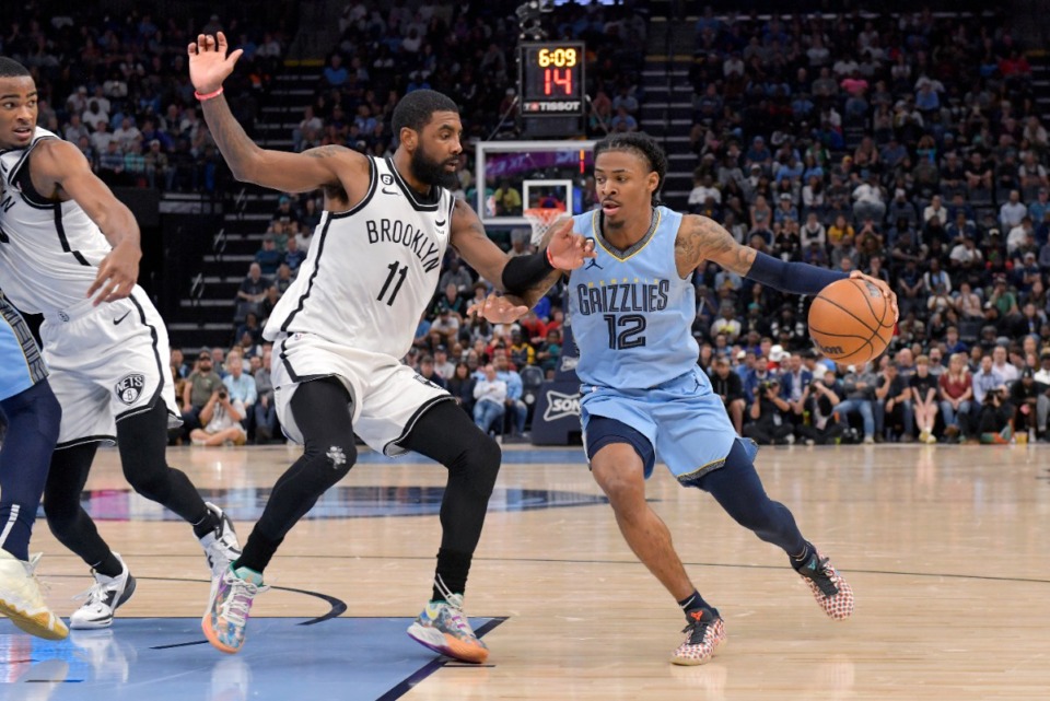 <strong>Memphis Grizzlies guard Ja Morant (12), who scored 38 points in Monday&rsquo;s game, battles Brooklyn Nets guard Kyrie Irving (11), who scored 37.</strong> (Brandon Dill/AP)