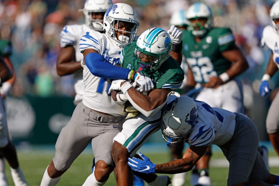 <strong>Tulane running back Shaadie Clayton (0) is tackled by Memphis defensive backs Quindell Johnson (15) and Ladarian Paulk (23) during the first half of an NCAA college football in New Orleans, Saturday, Oct. 22, 2022.</strong> (AP Photo/Tyler Kaufman)
