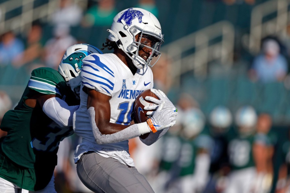 <strong>Memphis wide receiver Eddie Lewis (18) runs past Tulane safety Larry Brooks (31) to score a touchdown during the second half of an NCAA college football game in New Orleans, Saturday, Oct. 22, 2022. Tulane won 38-28. (</strong>AP Photo/Tyler Kaufman)