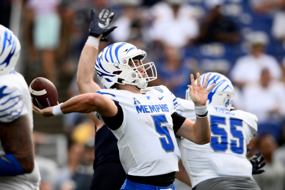 <strong>Memphis quarterback Seth Henigan (5) passes under pressure during the second half of an NCAA college football game against Navy, Saturday, Sept. 10, 2022, in Annapolis, Md. </strong>(Nick Wass/AP)