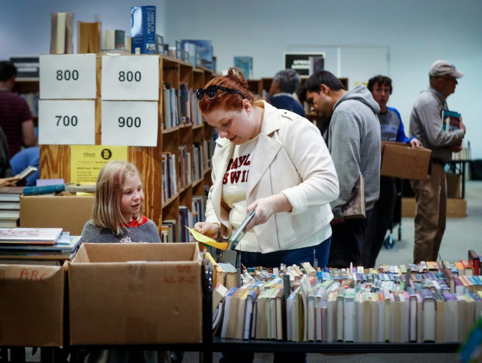 <strong>Book lovers look over the selections during the Benjamin L. Hooks Central Library&rsquo;s Friends of the Library Book Sale preview night on Thursday.</strong> (Mark Weber/The Daily Memphian)