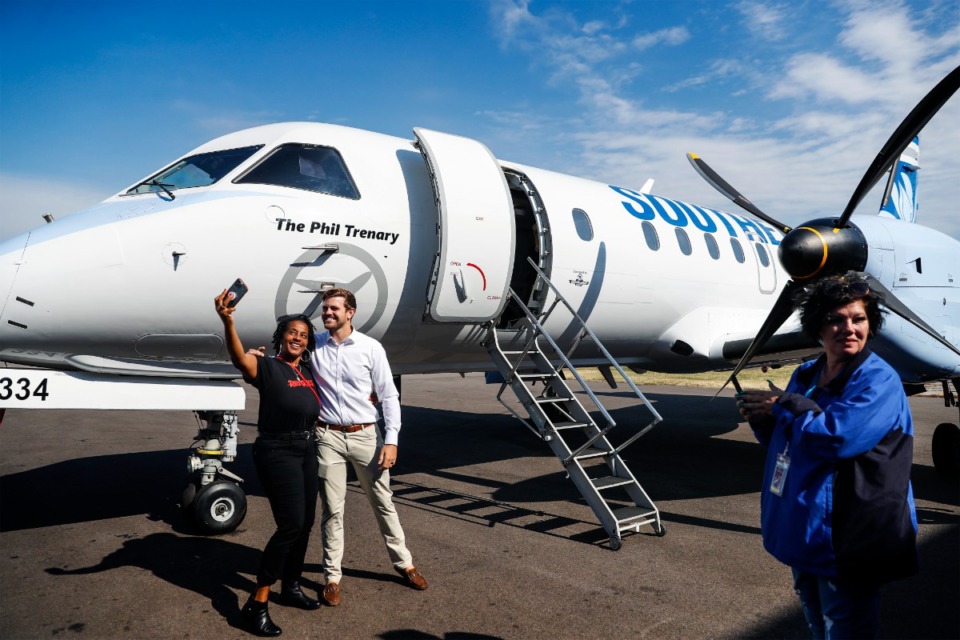 <strong>Pearce Trenary (middle) takes a photo in front Southern Airways Express&rsquo; newest Saab 340 aircraft, that was named in his father Phil Trenary&rsquo;s honor.</strong> (Mark Weber/The Daily Memphian)