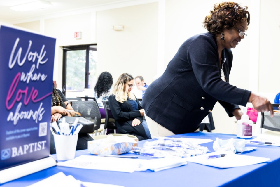 <strong>Donna Robinson (right) helps check people in during a job fair put on by Baptist for a new freestanding ER in Arlington. By the end of this year, Baptist plans to open its new freestanding ER in Arlington.</strong> (Brad Vest/The Daily Memphian)