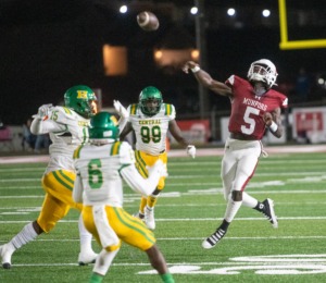 <strong>Munford High School's Jordan Bell passes in mid-air while a host of Central High School defenders surround him in the final regular season game for the unbeaten Munford Cougars. Munford went on to win the hard-fought, Oct. 28 contest 42-28.</strong> (Greg Campbell/Special to The Daily Memphian)