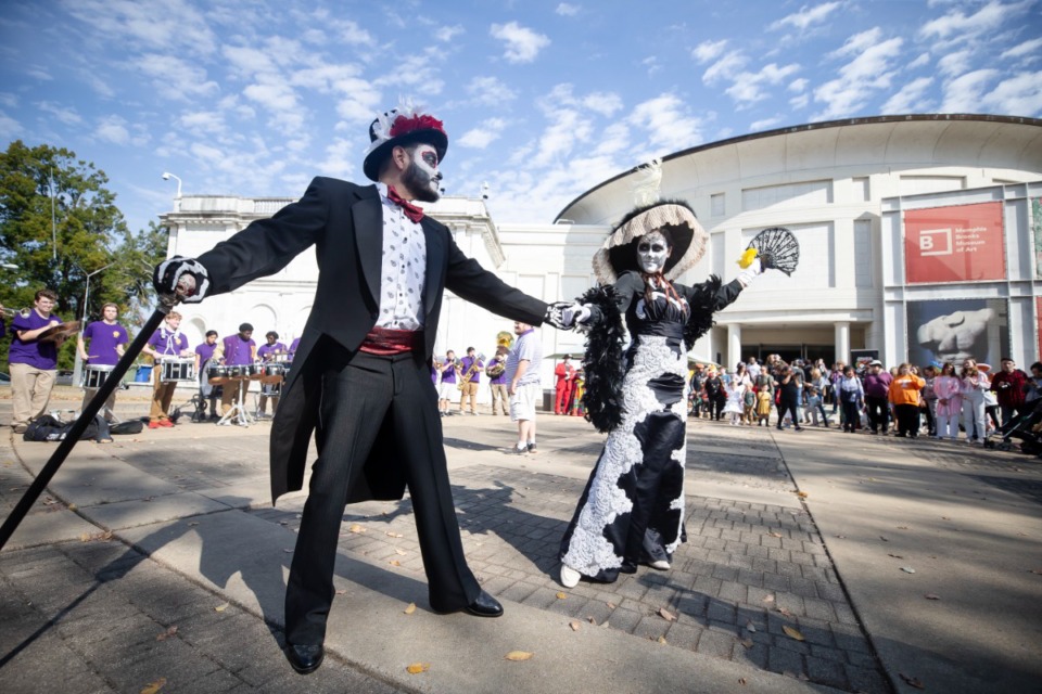 <strong>Gerardo Rivillas and Marianna Livingston dance to the music of Christian Brothers High School Marching Band in front of an audience during the Dias las Muertos festival at the Brooks Museum on Saturday Oct. 29, 2022. The holiday originated in Mexico and celebrates loved ones who have died.</strong> (Ziggy Mack/Special to The Daily Memphian)