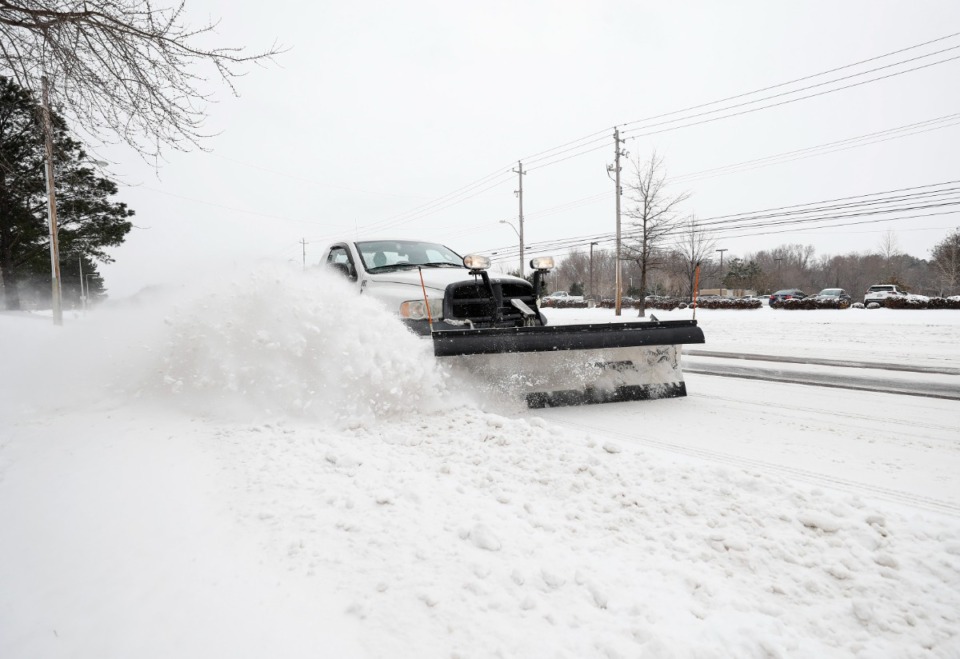 <strong>A plow clears snow on Wolf River Boulevard on Wednesday, Feb. 17, 2021 in Germantown.</strong> (Mark Weber/The Daily Memphian)