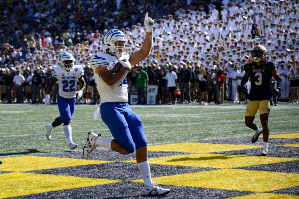 <strong>Memphis tight end Caden Prieskorn, foreground, celebrates his touchdown during the first half of an NCAA college football game against Navy, Saturday, Sept. 10, 2022, in Annapolis, Md. Navy cornerback Elias Larry (3) looks on.</strong> (AP Photo/Nick Wass)