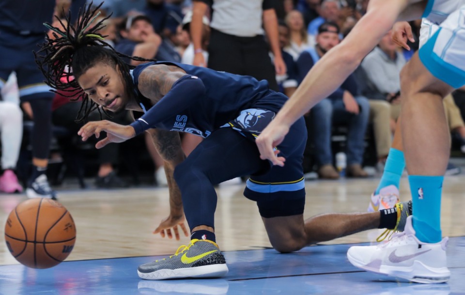 <strong>Memphis Grizzlies guard Ja Morant (12) dives for a loose ball, Nov. 4, 2022, in the game against the Charlotte Hornets.</strong> (Patrick Lantrip/Daily Memphian)
