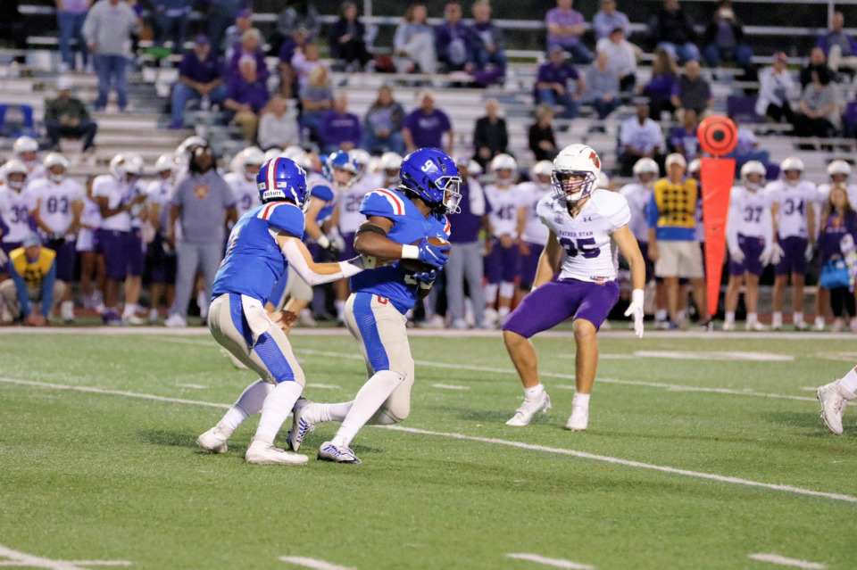 <strong>MUS quarterback Wilson LeMay (left) hands the ball to running back Tee Perry during the first-round playoff game between MUS and Father Ryan, Friday, Nov. 4, 2022.</strong> (Courtesy of Peyton Gallik)