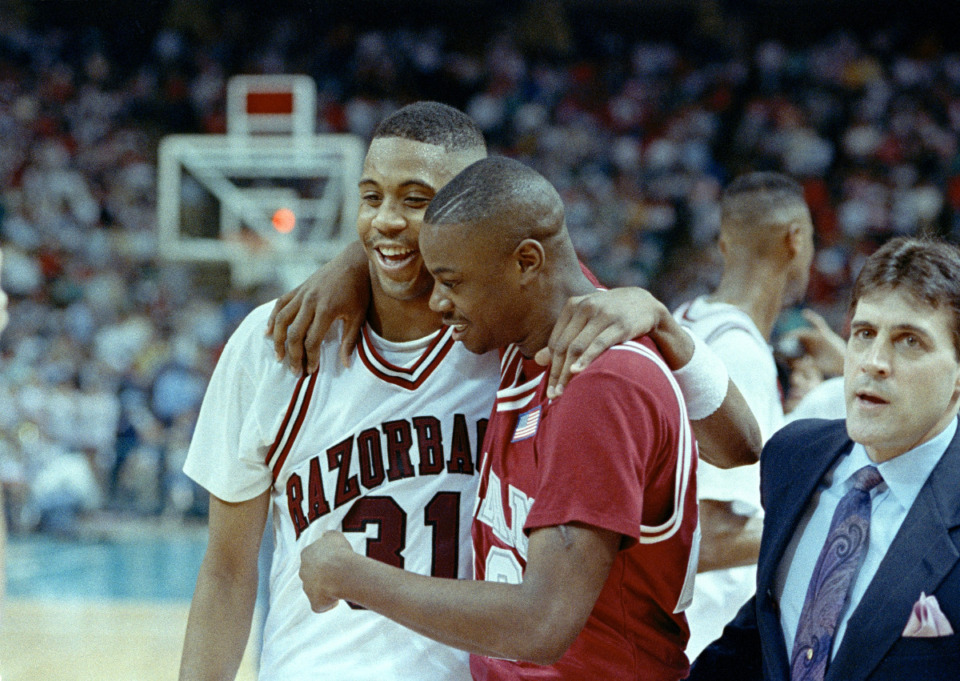 <strong>Arkansas' Ron Huery (31) smiles as he is hugged by Alabama's Marcus Jones following Arkansas' 93-70 NCAA Southeast Regional win over Alabama in Charlotte, N.C., March 21, 1991.</strong> (AP File Photo/Chuck Burton)