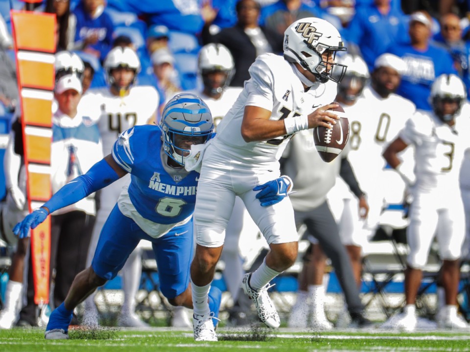 <strong>University of Memphis linebacker Zay Cullens (8) tries to wrap up UCF quarterback Mikey Keene (13) during a Nov. 5, 2022 game.</strong> (Patrick Lantrip/The Daily Memphian)