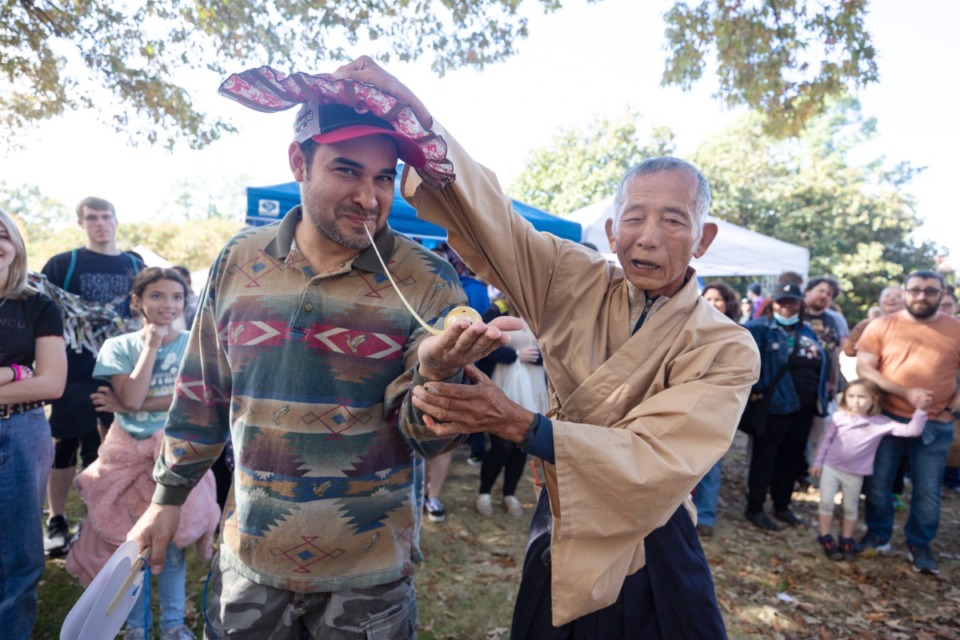 <strong>Masaji Terasawa (right), known as &ldquo;The Candyman,&rdquo; demonstrates one of his magic tricks at the Memphis Japan Festival at Memphis Botanic Garden on Sunday, Nov. 6, 2022.</strong>&nbsp;(Ziggy Mack/Special to The Daily Memphian)&nbsp;