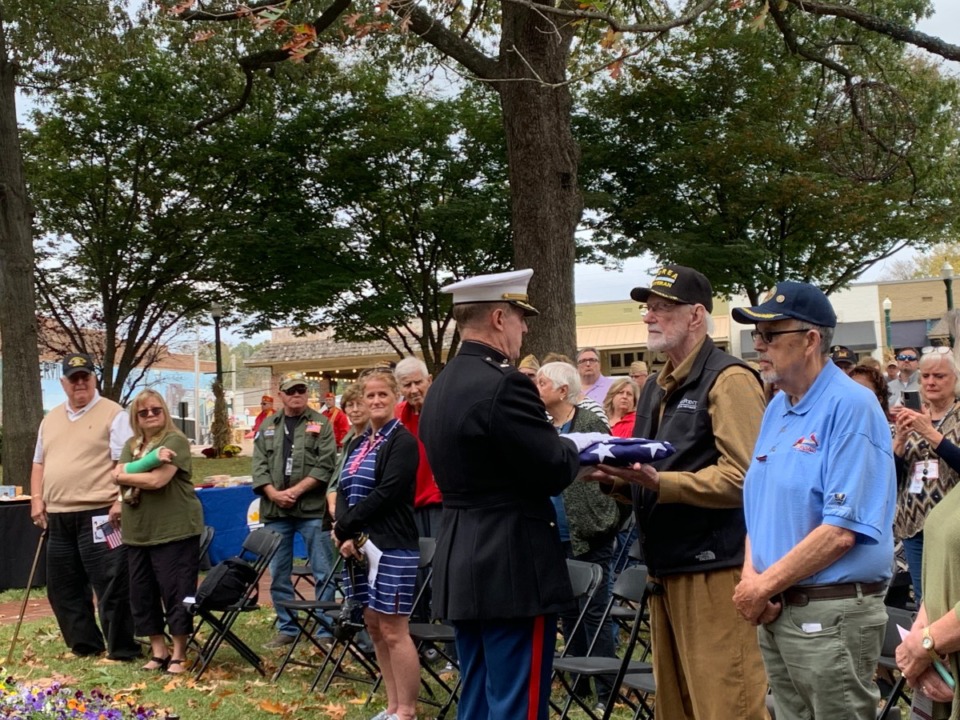 <strong>Gene Cartwright, who served in the Army during the Korean War, accepts a flag Sunday at Collierville Town Square Park, where a Veterans Day event was held.</strong> (Abigail Warren/The Daily Memphian)