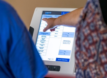 <strong>Alana Blackstone with the Shelby County Election Commission points to the touch screen on the new voting machines during a demontration at New Bethel MB Church in Germantown last July.</strong> (Greg Campbell/Special to The Daily Memphian)