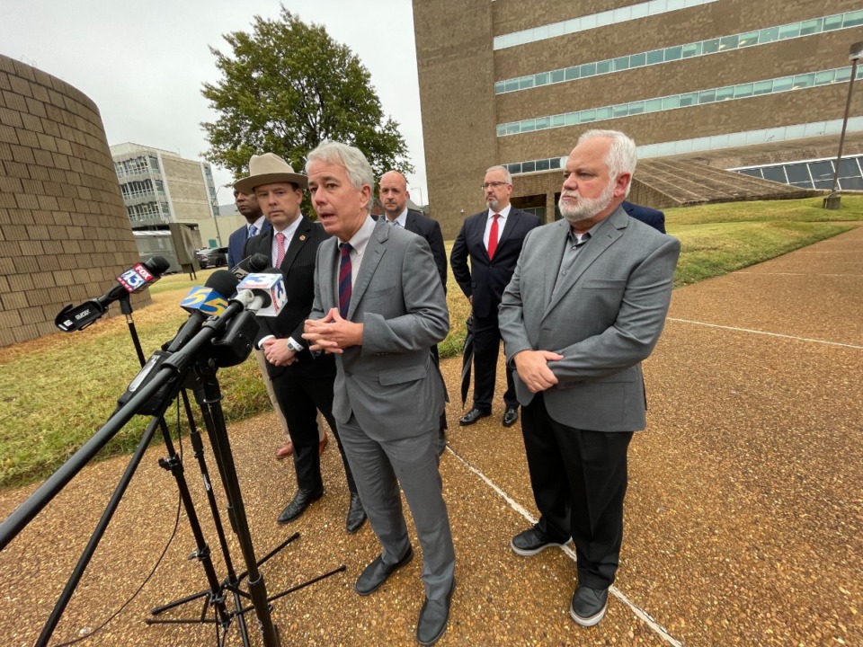 <strong>Shelby County District Attorney Steve Mulroy (center) speaks Monday, Nov 7, 2022 outside the Shelby County Justice Center. He was joined members of the Shelby County District Attorney&rsquo;s Office and 28th Judicial District Attorney Frederick Agee (in hat) and Lance Huey (right), a former Arkansas sheriff and co-chairman of Responsible Growth Arkansas.</strong> (Julia Baker/The Daily Memphian)