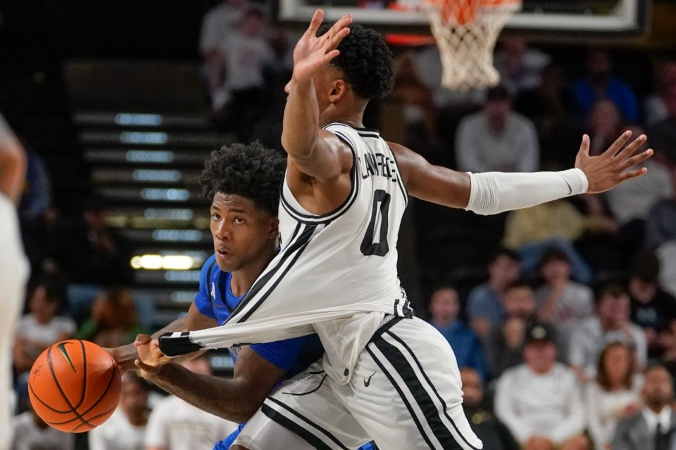 <strong>Memphis guard Kendric Davis, left, pulls the jersey of Vanderbilt guard Tyrin Lawrence (0) in the second half of an NCAA college basketball game Monday, Nov. 7, 2022, in Nashville.</strong> (AP Photo/Mark Humphrey)