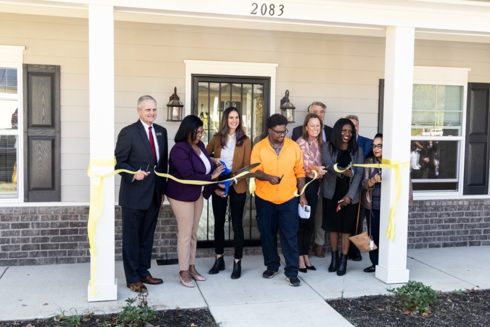 <strong>A ribbon is cut during a ceremony&nbsp; at the new Wolf River Bluffs subdivision in Frayser.&nbsp;</strong>(Brad Vest/Special to The Daily Memphian)