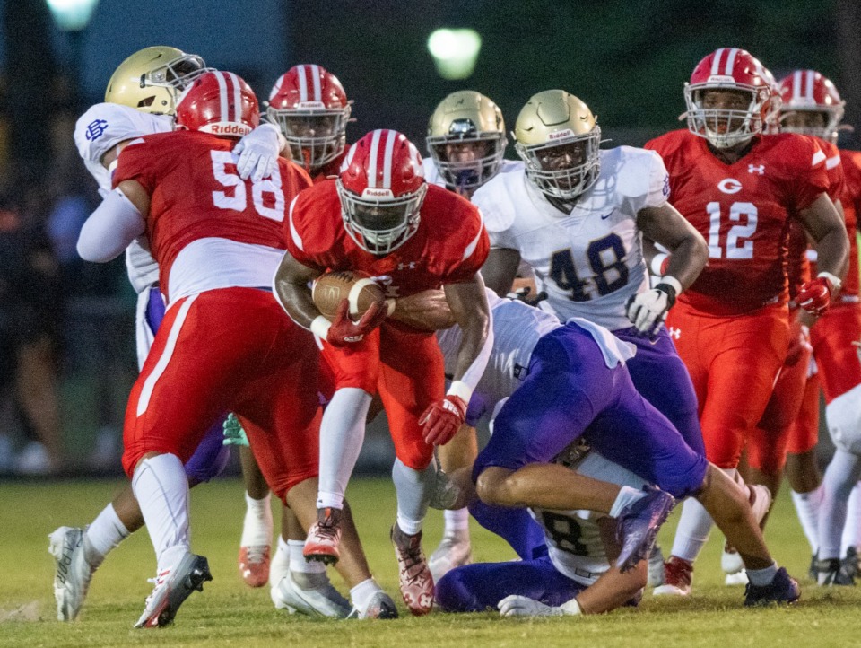 <strong>Germantown's B.J. Blake fights the defensive line of CBHS to make a first down in the second quarter of their game at Germantown High School, Saturday, Aug. 20, 2022.</strong> (Greg Campbell/Special to The Daily Memphian)