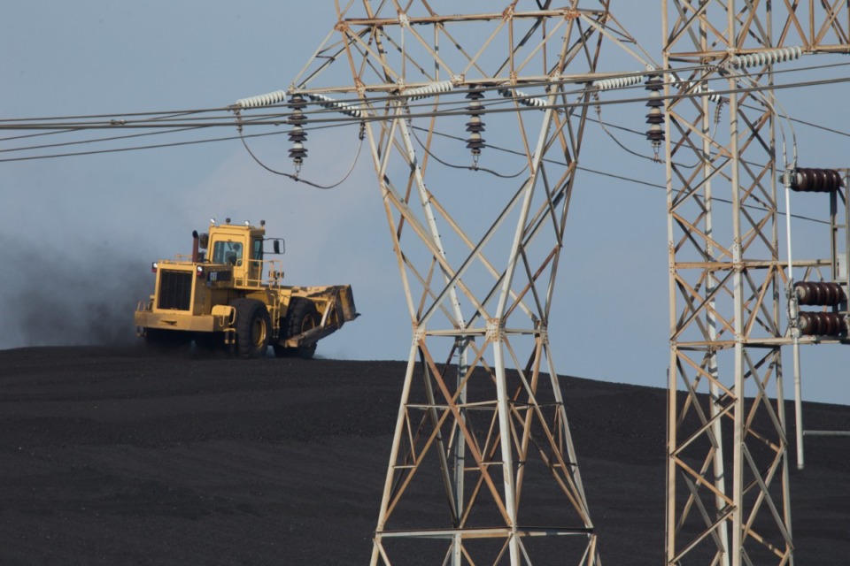 <strong>A bulldozer climbs the coal mound at TVA Allen Fossil Plant,&nbsp;located near Presidents Island. A recent report ranks it No. 10 on a new list of the most contaminated coal ash cleanup sites in the country.&nbsp;</strong>(The Daily Memphian file)