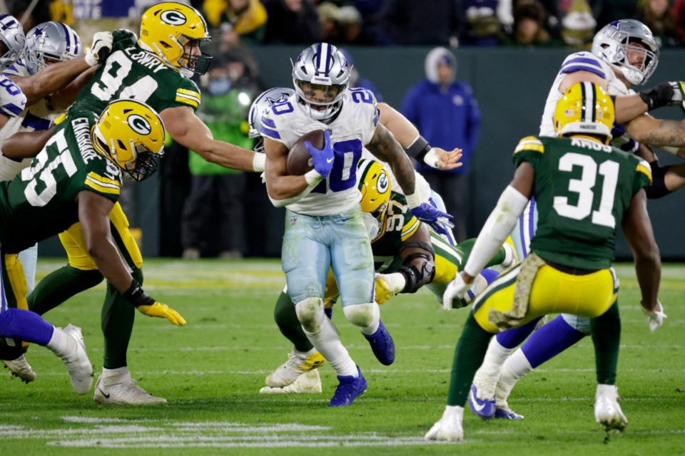 <strong>Dallas Cowboys running back Tony Pollard (20) runs the ball as Green Bay Packers' Dean Lowry (94), Kingsley Enagbaren (55) and Kenny Clark (97) attempt to make the stop during overtime of an NFL football game Sunday, Nov. 13, 2022, in Green Bay, Wis.</strong> (AP Photo/Mike Roemer)