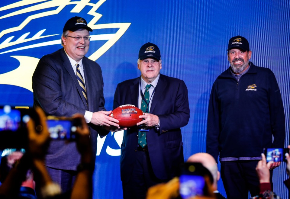<strong>Memphis Mayor Jim Strickland (left) FedEx founder Fred Smith (middle) and Memphis Showboats head coach Todd Haley (right) attend a press conference announcing the teams return to the USFL Tuesday, Nov. 15, 2022.</strong> (Mark Weber/The Daily Memphian)